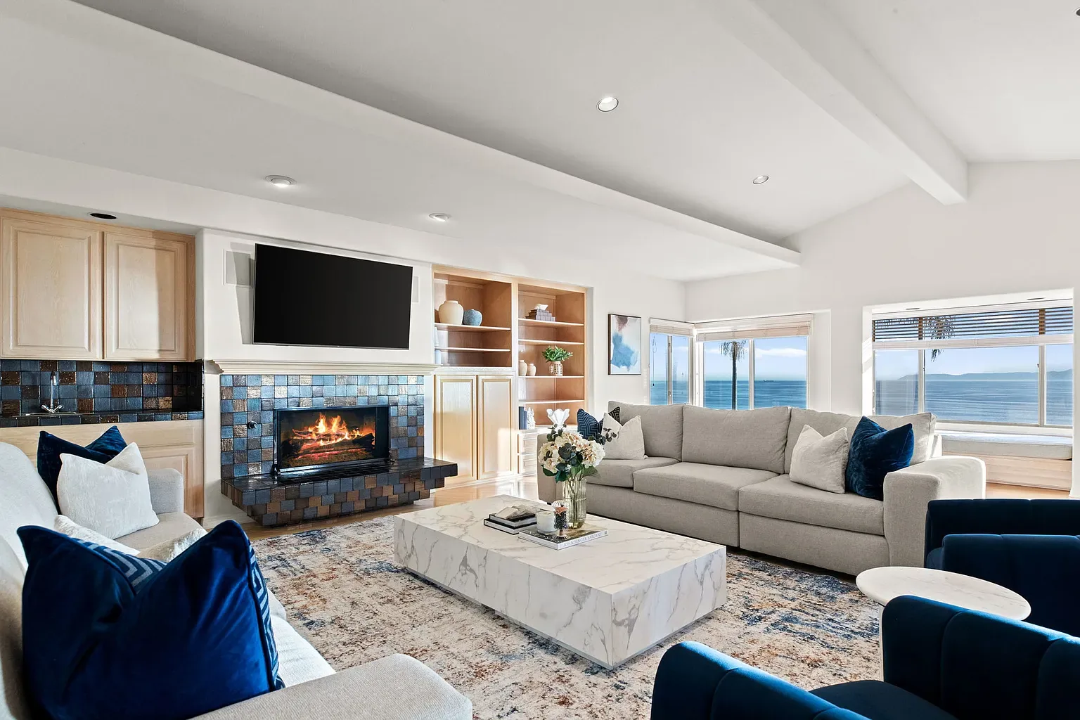Living room with fireplace and ocean views